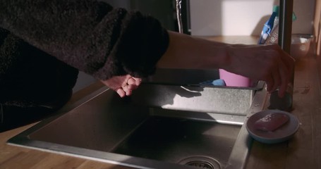 Woman Washing Hands with Soap in Kitchen Sink