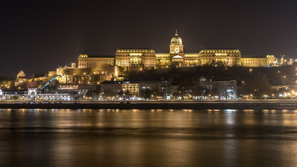 Buda Castle by the Danube river illuminated at night in Budapest, Hungary