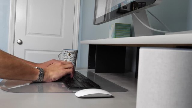 Person typing on keyboard, working from home on computer, closeup side truck