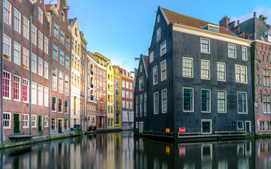 Naklejka premium Amsterdam, the Netherland - March, 28th 2020 : Amsterdam sunset colorful houses on a water with reflection 