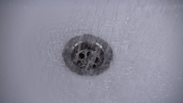 The water is washed into the water drain. Slow motion.
