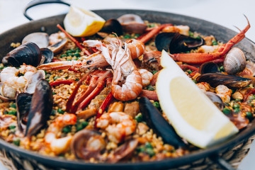 Very tasty seafood paella in the frying pan, traditional spanish food