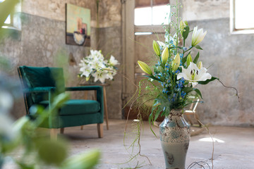 flower arrangement with white lilies in a industrial interior