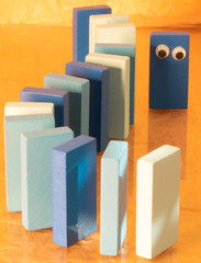 Toy dominos with eyes in a position of solidarity during the pandemic corona virus