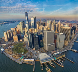 Aerial view of the Manhattan business district with modern office towers and battery park during golden hour     