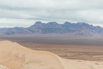 The view on the mountains behind the sand dunes in Mojave national preserve