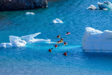 Kayaking in Arctic sea near iceberg
