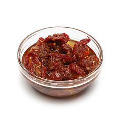 Sun dried tomatoes with olive oil in bowl on white background with shadow