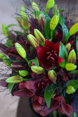 close up of a bouquet with red lilies