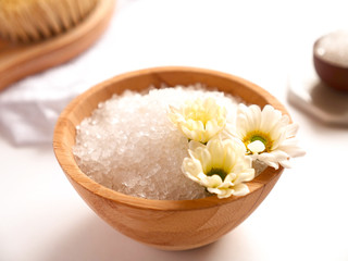 Fototapeta na wymiar Spa composition. Sea salt, bath towel and flowers on white background. Close up. Home care concept