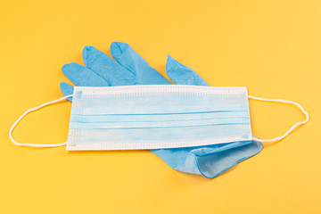 Medical masks and rubber gloves on a yellow background. Corona virus. Healthcare and medical...