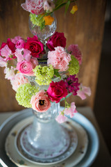bouquet with red roses and ranunculus in a glass vase