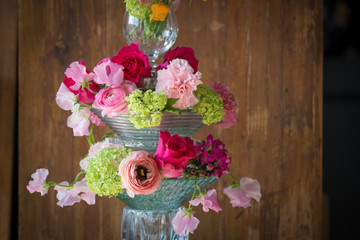 bouquet with red roses and ranunculus in a glass vase