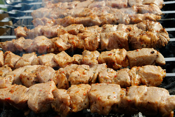 Grilled kebab cooking on metal skewers (grill).