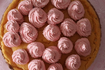 Colorful birthday cake with chocolate and pink cream toppings