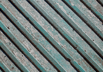 Texture of grunge tile with volumetric diagonal stripes in aqua menthe color. Teal worn floor with diagonal lines