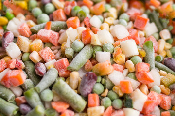 frozen vegetables close up. A cocktail of frozen chopped vegetables close-up as background.