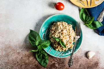 Risotto with tomatoes on a green plate with basil. Italian food. Vegan food concept. Italian cuisine. Tomato dish. Healthy food. Summer dish. Homefood.