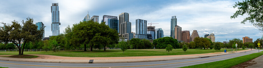 Obraz na płótnie Canvas Panoramic View of Downtown Austin Skyline from Riverside Dr Street with Mostly Clear Skies