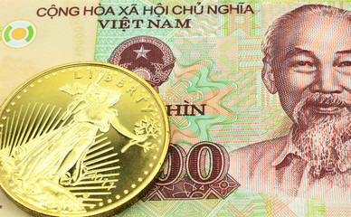 A macro image of a colorful 10000 dong note from Vietnam with a gold coin.  Shot close up.