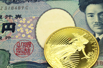 A macro image of a grey 1000 Japanese yen bill with a gold coin.  Shot close up.