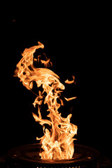 Hot flame of fire from a homemade stove on a black background
