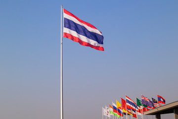 Thailand national flag on top of pole in blue sky backround