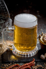 Light beer in a glass, on an old background.