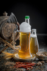 Light frothing beer in a glass, on an old background.