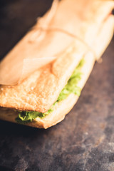 Freshly cooked sandwiches with roasted chicken, tomatoes and salad leaves. Selective focus. Shallow depth of field.