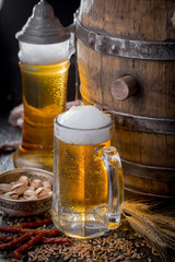 Light beer in a glass, on an old background.