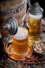 Light beer in a glass, on an old background.