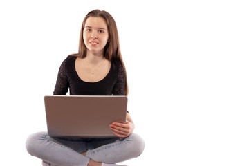 girl sitting with a laptop, smiling and looking forward