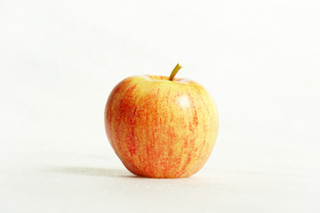 Red glossy apple on white background. Template healthy food with eco fruit. Closeup
