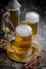 Light beer in a glass, on an old background.