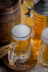 Light frothing beer in a glass, on an old background.