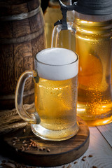 Light beer in a glass, on an old background.