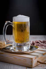 Light beer in a glass, on an old background.