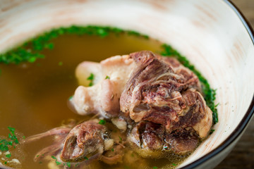 soup with veal on wooden table