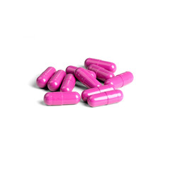 Obraz na płótnie Canvas A bunch of pink pills isolated on a white background