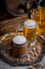 Light beer in a glass, on an old background.