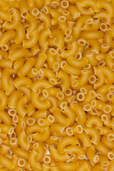 Flat lay of layer of macaroni on white porcelain plate