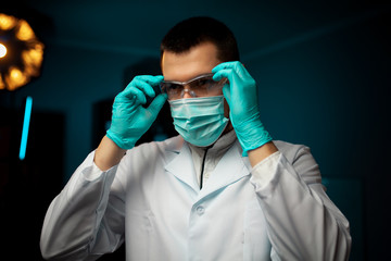 Biologist examines sample. Science, biology, ecology. Professional scientist wearing protective...