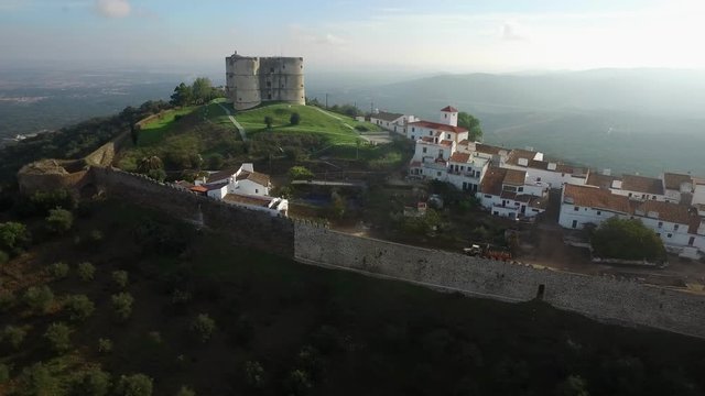 Portuguese Evoramonte clover tower inside the castle. Aerial panoramic drone shot on a sunny morning.