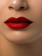 Fototapeta premium Sexual full lips. Natural gloss of lips and woman's skin. The mouth is closed. Increase in lips, cosmetology. red lipstick. Open mouth and with teeth. blonde hair.