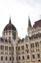 Fototapeta na wymiar Building of the Hungarian Parliament Orszaghaz in Budapest, Hungary. The seat of the National Assembly. Detail photo of the facade. House built in neo-gothic style. Vertical photo