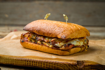 meat sandwich with ciabatta on old wooden table