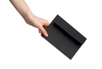 Female hand with manicure holding envelope isolated on white background
