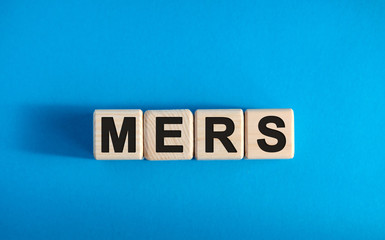 MERS - text on wooden blocks, medical concept, blue background