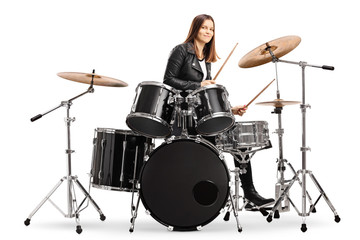 Young female drummer playing drums